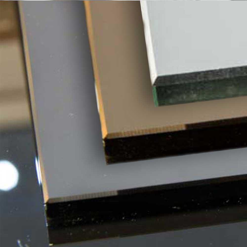 Stacked architectural glass samples in grey, beige, white, and black for bespoke commercial & residential projects