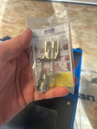 Hand holding packaged Proliner measuring pen bracelet tool for glass installation