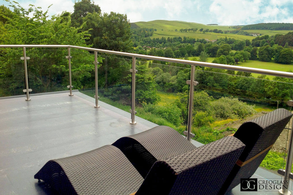 Glass terrace balustrade with stainless steel posts and countryside views
