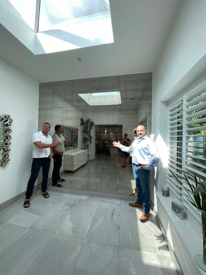 Floor-to-ceiling antique mirror feature wall in a private London residence