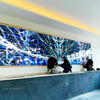 Installation of a large digital display with abstract blue and white design.