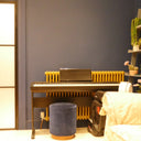Modern room with a digital piano, blue walls, a frosted glass hinged door, and decorative shelving