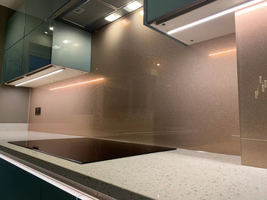 Rose gold fine glitter kitchen glass splashback made and installed by CreoGlass in London UK