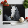 Rectangular chopping board with white horse painting surrounded by cherry tomatoes, basil, garlic, and kitchen knife