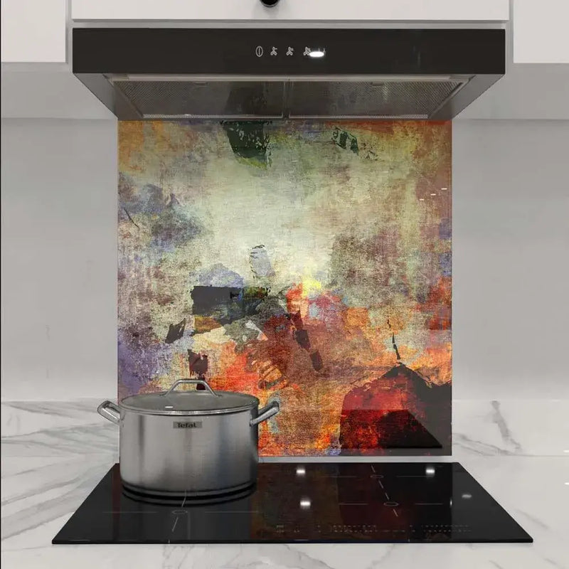 Abstract art glass splashback in modern kitchen with induction hob and stainless steel pot