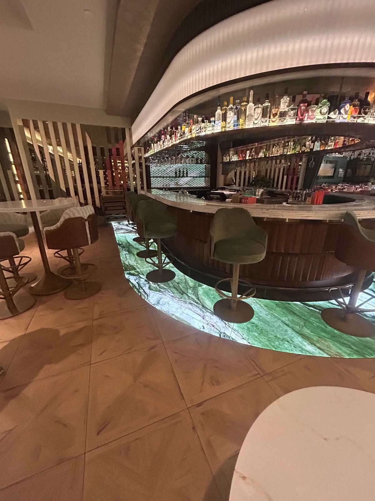 Illuminated Patagonia Green walk-on glass floor surrounding the bar at Fairmont Windsor Park