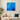 Abstract blue ice cave wall art print with swirling patterns hanging above beige sofa