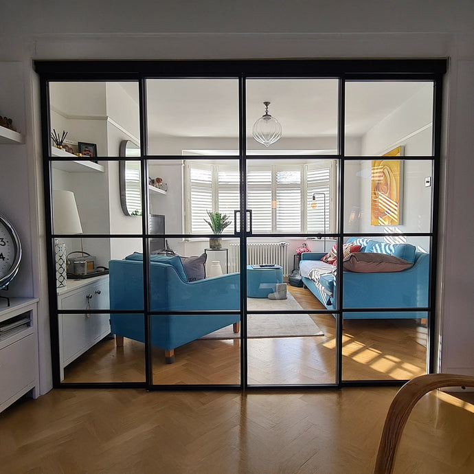 Modern living room with blue sofa and glass partition