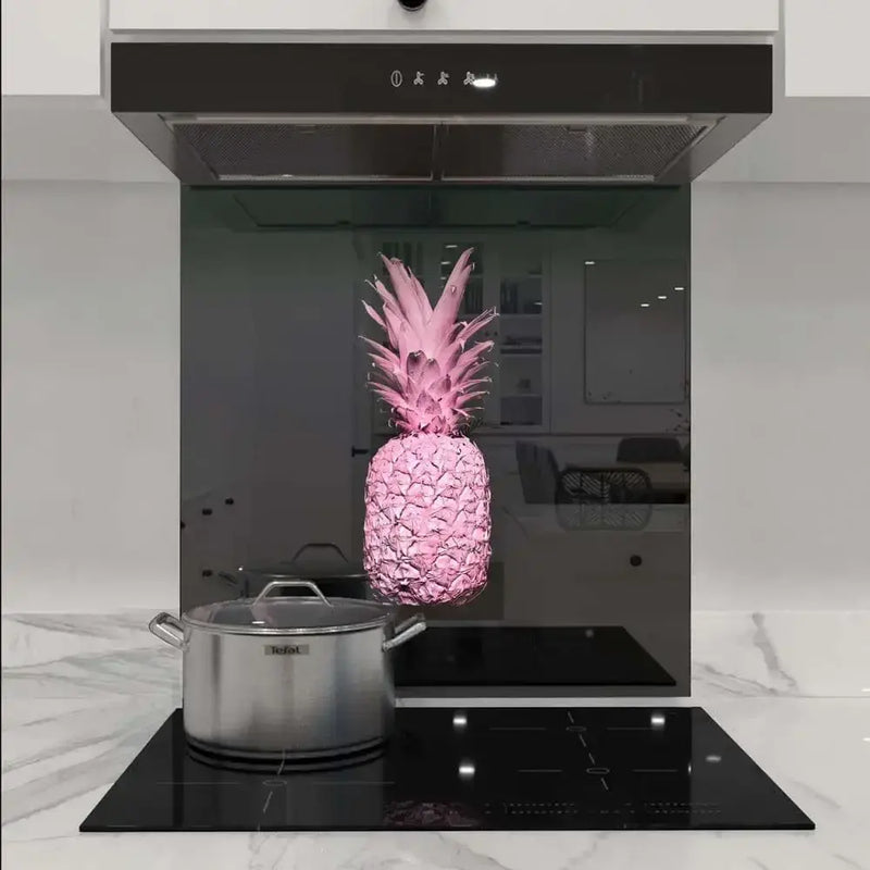 Pink pineapple decorative glass splashback in modern kitchen with induction hob