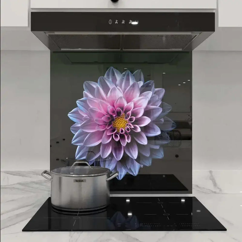Bespoke floral glass splashback with pink dahlia design in modern kitchen, featuring sleek black hob and marble worktop