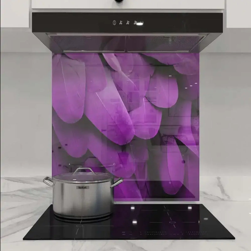 Purple feather-patterned decorative glass splashback in modern kitchen with induction hob