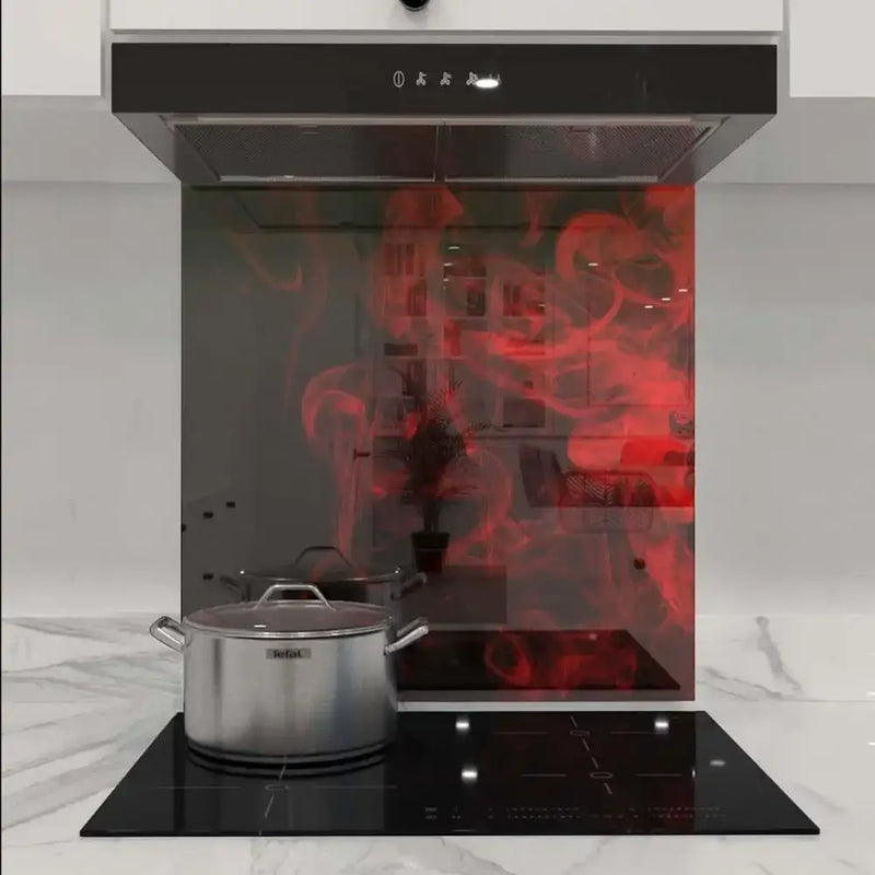 Red abstract LED backlit glass kitchen splashback with modern hob and extractor hood