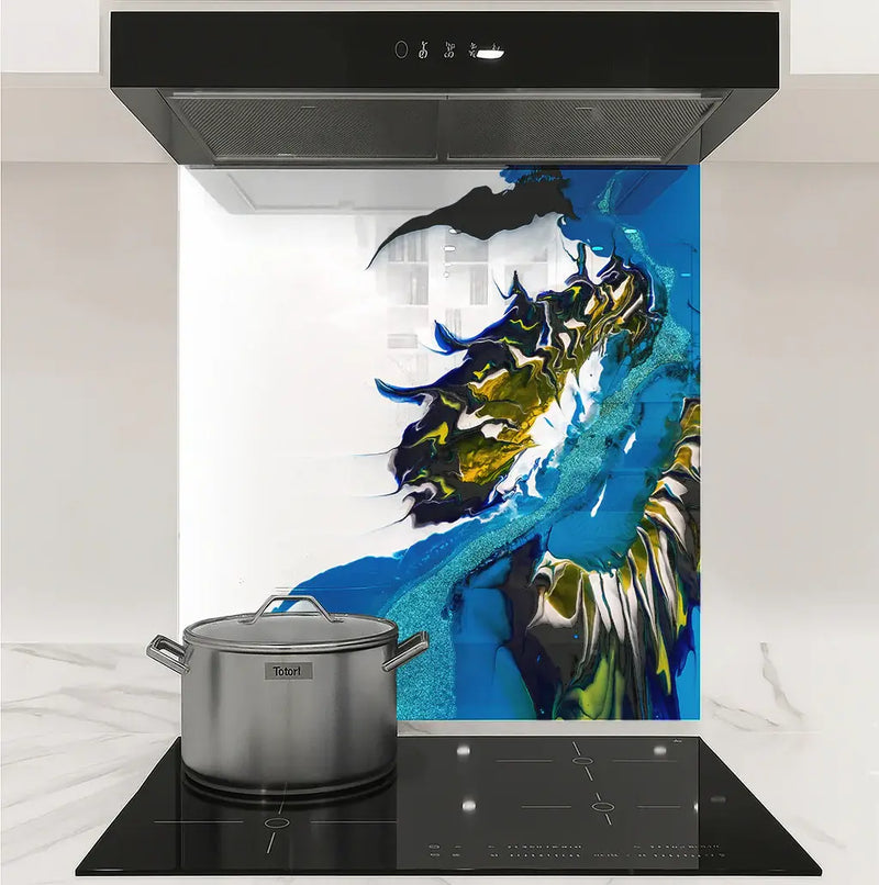 Modern kitchen stovetop with stainless steel pot and colorful blue, yellow, black, and white abstract backsplash