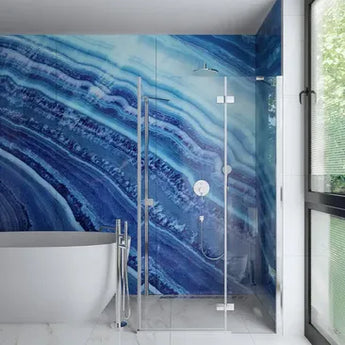 Modern bathroom with a blue marble-patterned shower wall and white bathtub.