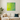 Modern living room with white sofa, beige and dark blue pillows, green plant, and vibrant green-blue abstract wall art