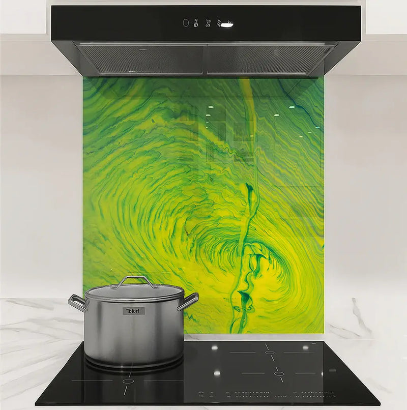 Modern kitchen stovetop with stainless steel pot and colorful green-yellow vortex backsplash
