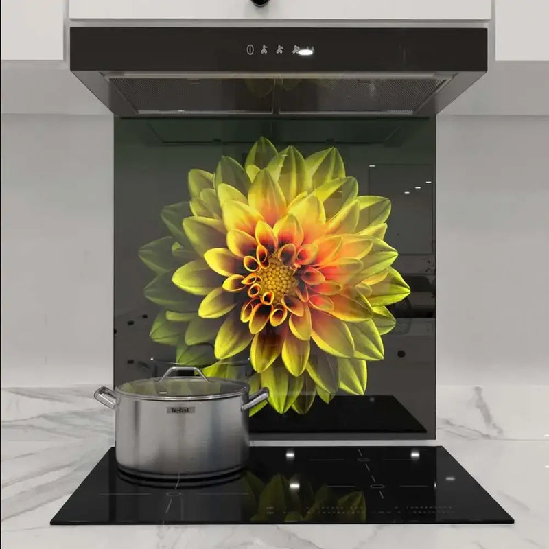 Vibrant floral print glass splashback in modern kitchen, featuring yellow dahlia design behind induction hob.