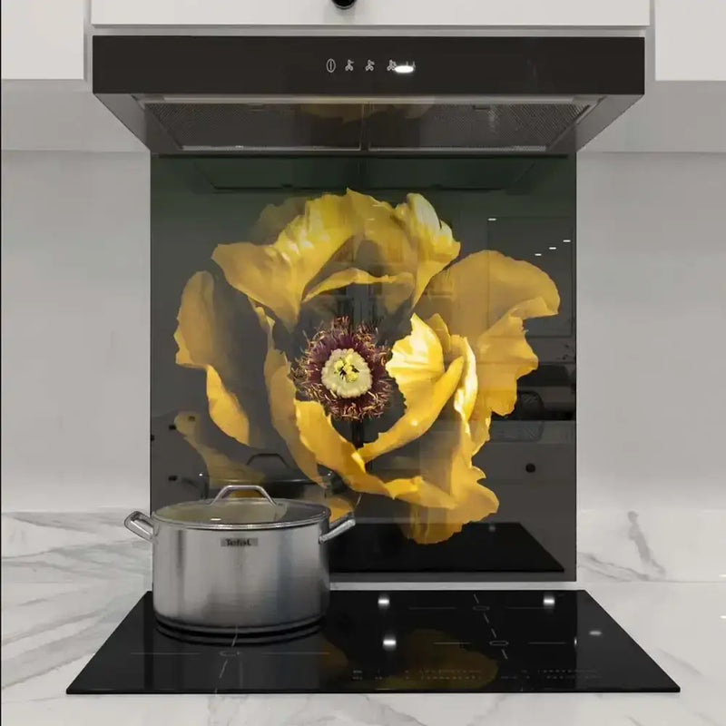 Custom kitchen glass splashback with vibrant yellow flower design, modern induction hob and marble countertop
